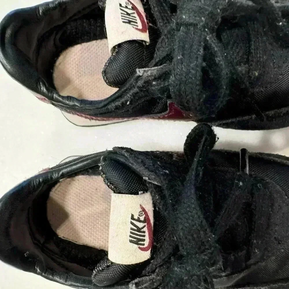 Nike baby girl suede sneakers size 6c. Black with burgandy nike logo.